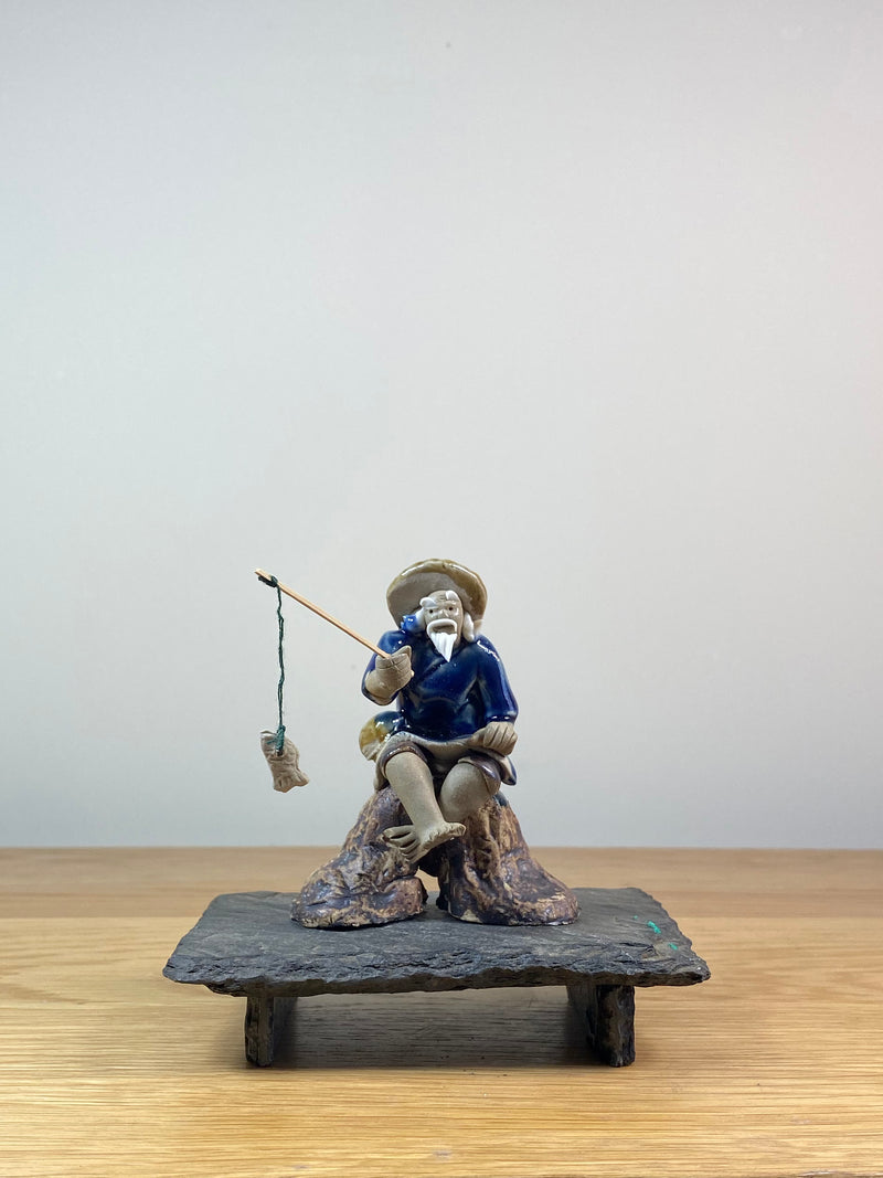 FISHERMAN ON STUMP